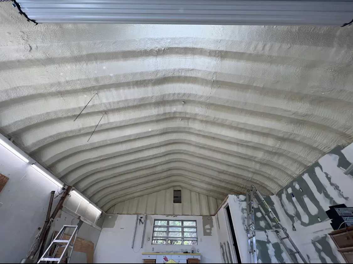 Spray polyurethane foam applied to the underside of a metal roof deck in Griffith